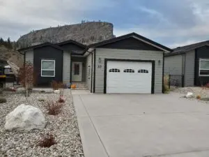 A house with a garage and driveway in front of it.