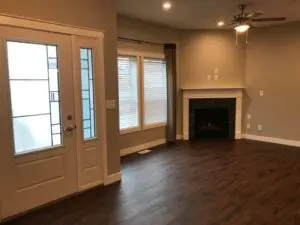 A living room with hard wood floors and fireplace.