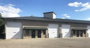 A large building with two doors and a green roof.